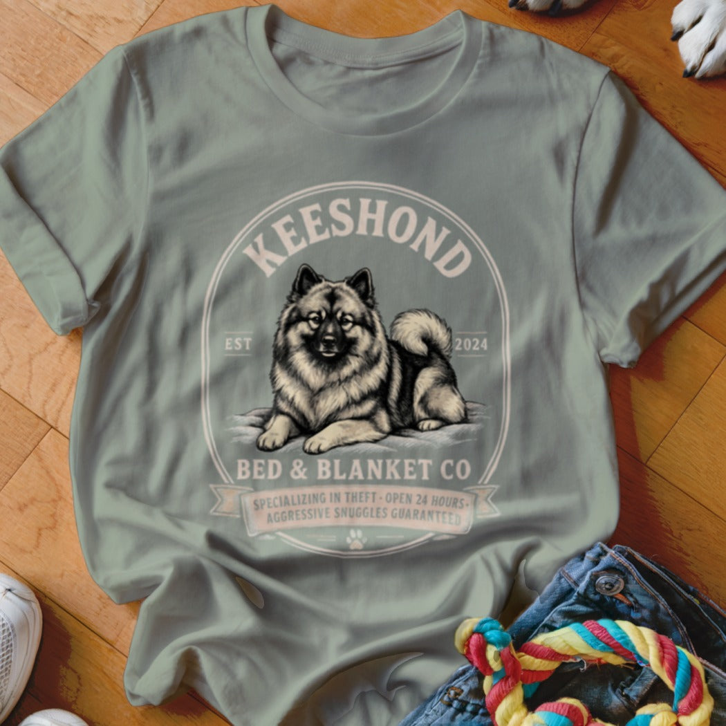 Keeshond dog illustration with text "Bed & Blanket Co." on a shirt.
