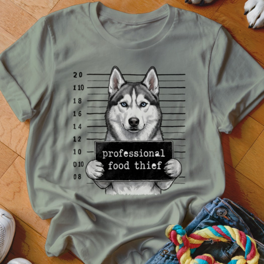 Husky dog mugshot with "professional food thief" text on a light green shirt.