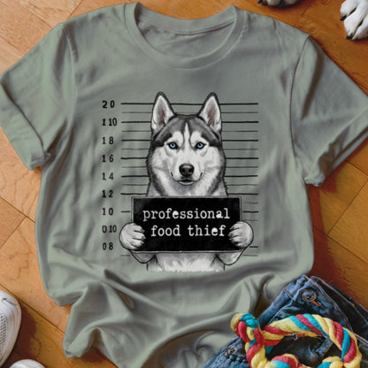 Husky dog mugshot with "professional food thief" text on a light green shirt.