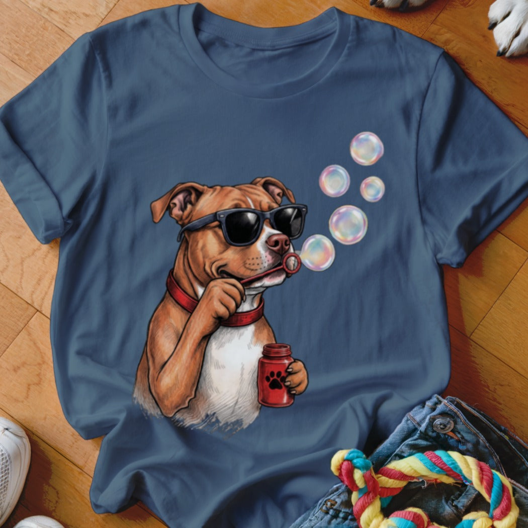 Blue t-shirt featuring a graphic of a brown dog wearing sunglasses and blowing soap bubbles.