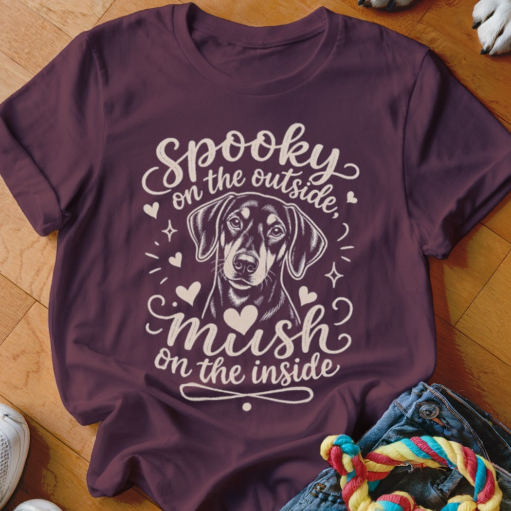 Burgundy t-shirt with a dog and text "Spooky on the outside, mush on the inside."
