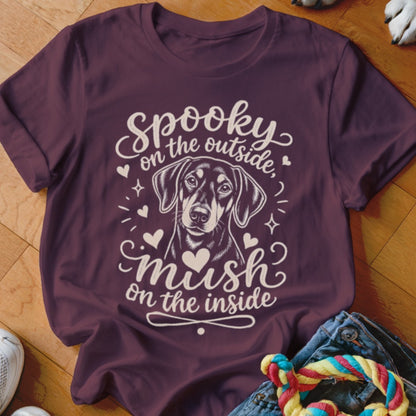 Burgundy t-shirt with a dog and text "Spooky on the outside, mush on the inside."