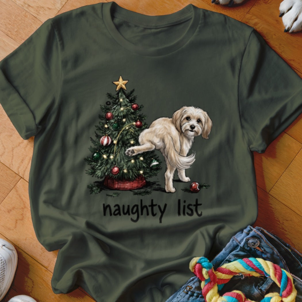 Olive green t-shirt with a drawing of a dog next to a Christmas tree, reading "naughty list".
