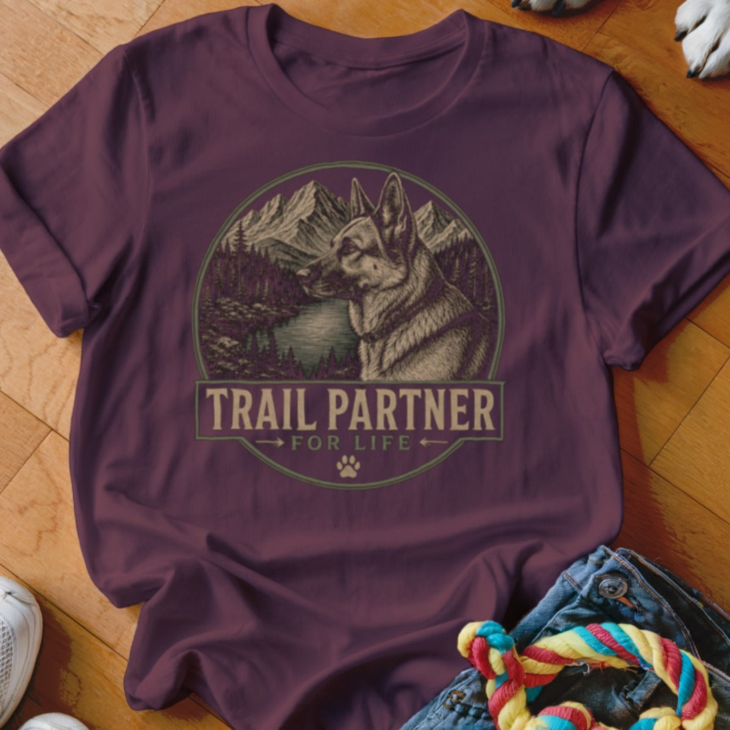 Maroon t-shirt with "TRAIL PARTNER FOR LIFE" text and German Shepherd in mountain landscape.