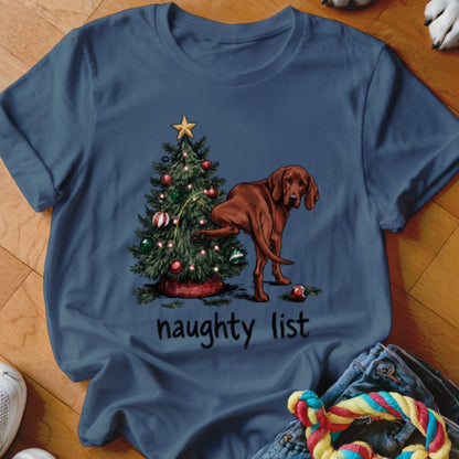 Brown dog lifting leg on Christmas tree with "naughty list" text.