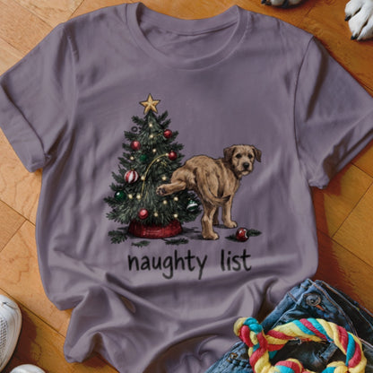 Purple t-shirt featuring a puppy urinating on a decorated Christmas tree with the text naughty list.