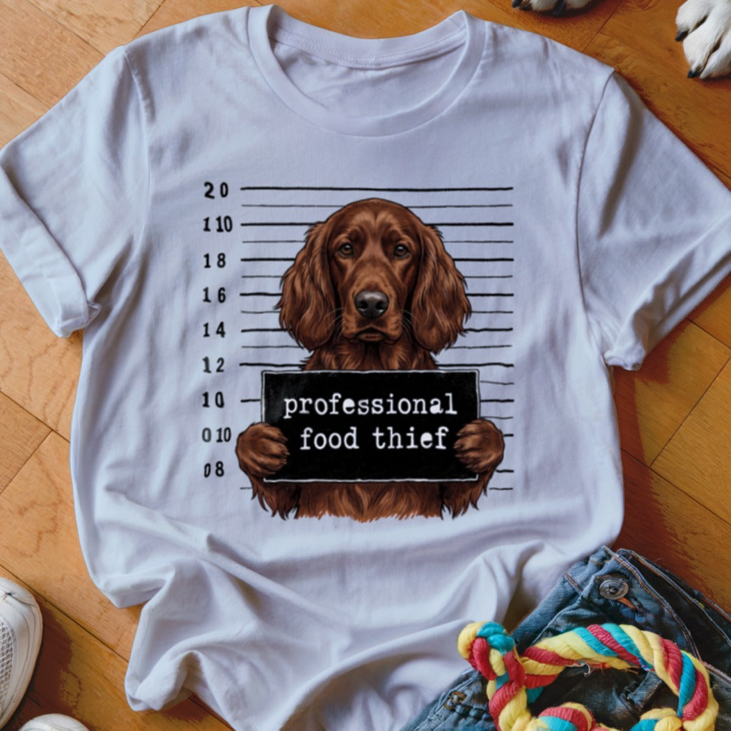 White t-shirt featuring a brown setter dog mugshot with "professional food thief" sign.