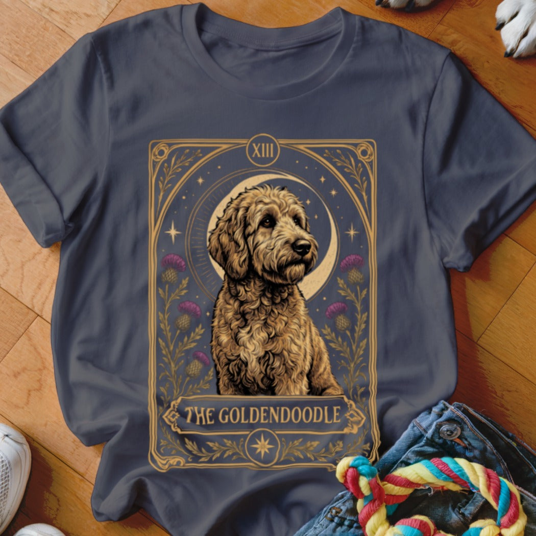 Dark grey t-shirt featuring a tarot card style illustration of a Goldendoodle with purple thistles.