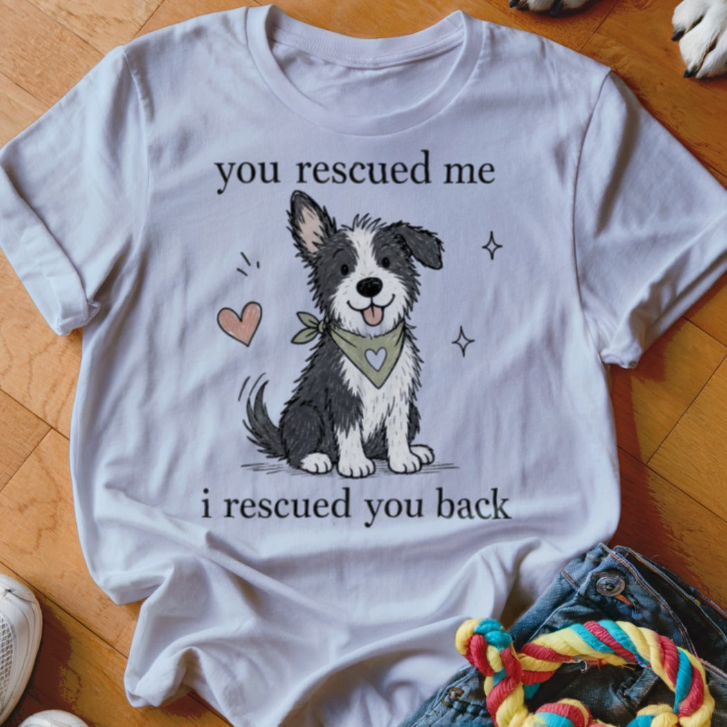 White t-shirt with a cartoon dog and text: "you rescued me, i rescued you back".