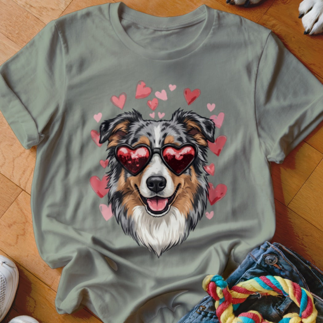 Sage green crewneck t-shirt featuring an illustration of an Australian Shepherd wearing heart-shaped sunglasses surrounded by pink hearts.