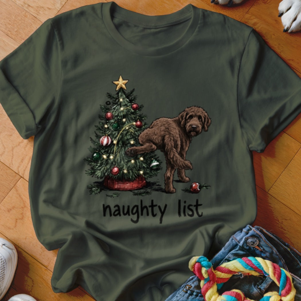 Brown dog humorously interacting with a Christmas tree, reads "naughty list".