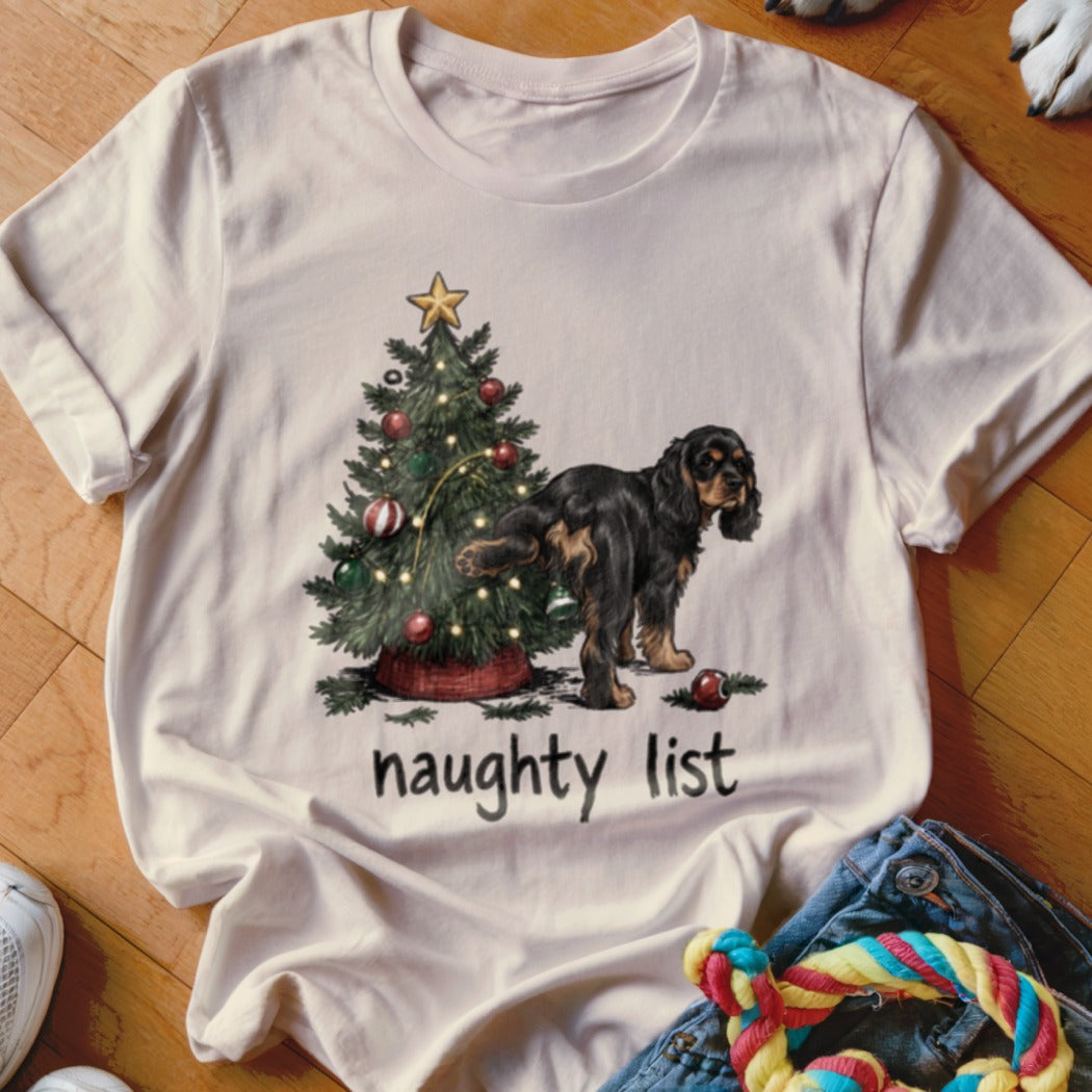 T-shirt with a Christmas tree and a dog by the text "naughty list".