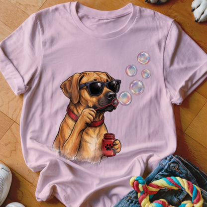 Light pink t-shirt featuring a graphic of a brown dog wearing sunglasses and blowing soap bubbles.
