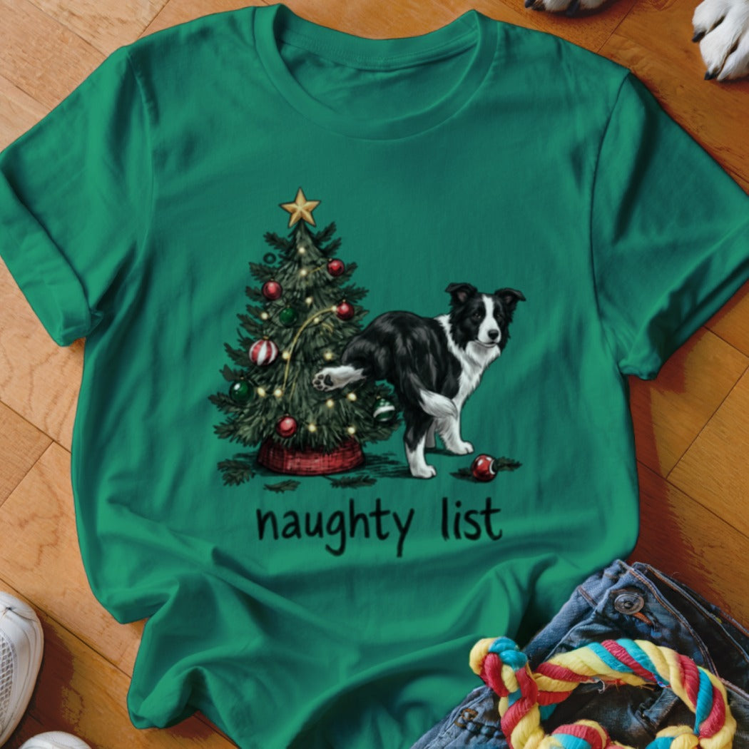 Green t-shirt with a border collie near a Christmas tree, reading "naughty list".
