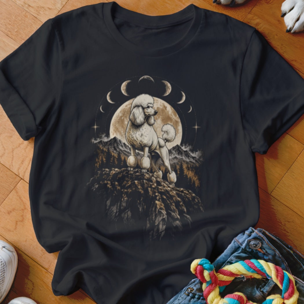 Black t-shirt featuring a graphic of a white poodle standing on a mountain before a full moon and moon phases.