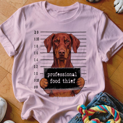 T-shirt graphic of a dog with a "professional food thief" sign.