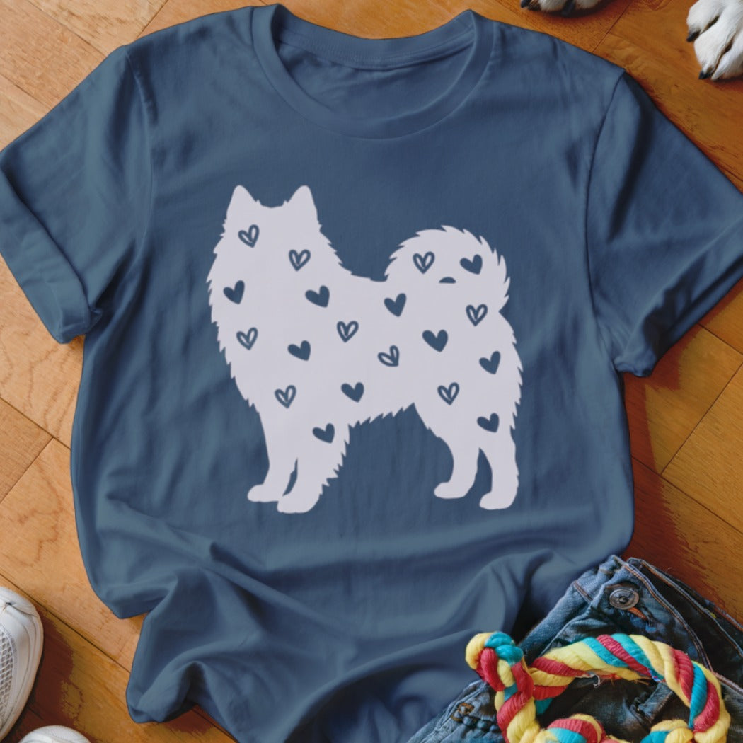 White dog silhouette filled with scattered dark blue hearts on a navy t-shirt.