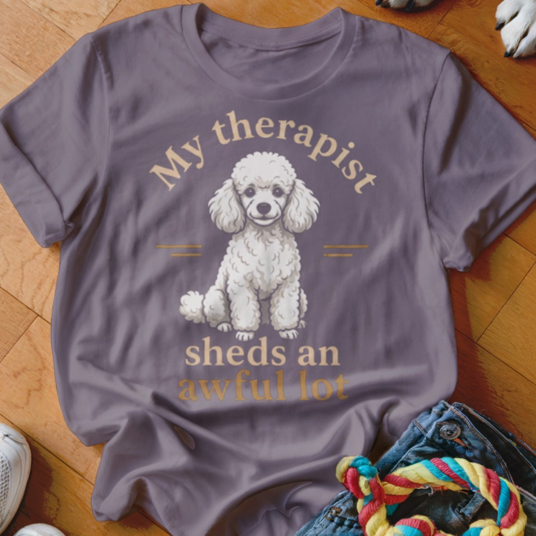 T-shirt with white poodle illustration and text "My therapist sheds an awful lot".
