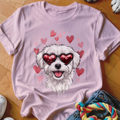 Light pink crewneck t-shirt featuring an illustrated white dog wearing heart-shaped sunglasses, surrounded by pink hearts.