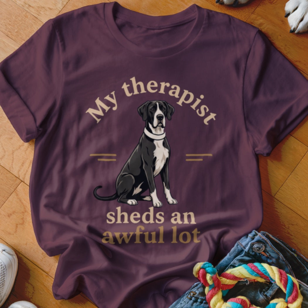 Great Dane graphic with text "My therapist sheds an awful lot" on a t-shirt.