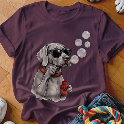 A dark purple crewneck t-shirt featuring a graphic of a dog wearing sunglasses and blowing bubbles.