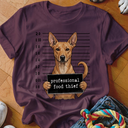 T-shirt with illustration of a dog in front of a police lineup holding a "professional food thief" sign.