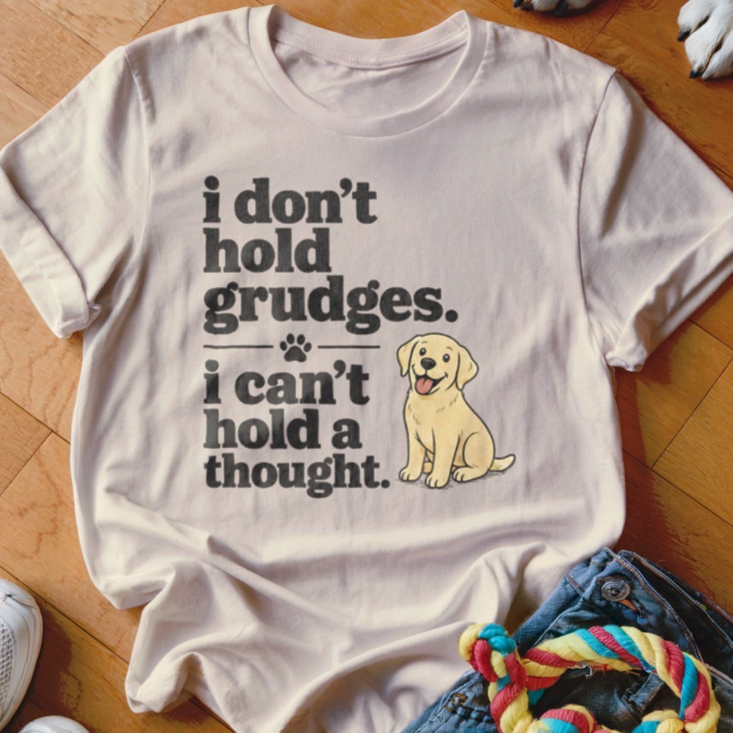 White t-shirt with text "i don't hold grudges. i can't hold a thought." and a cartoon dog.