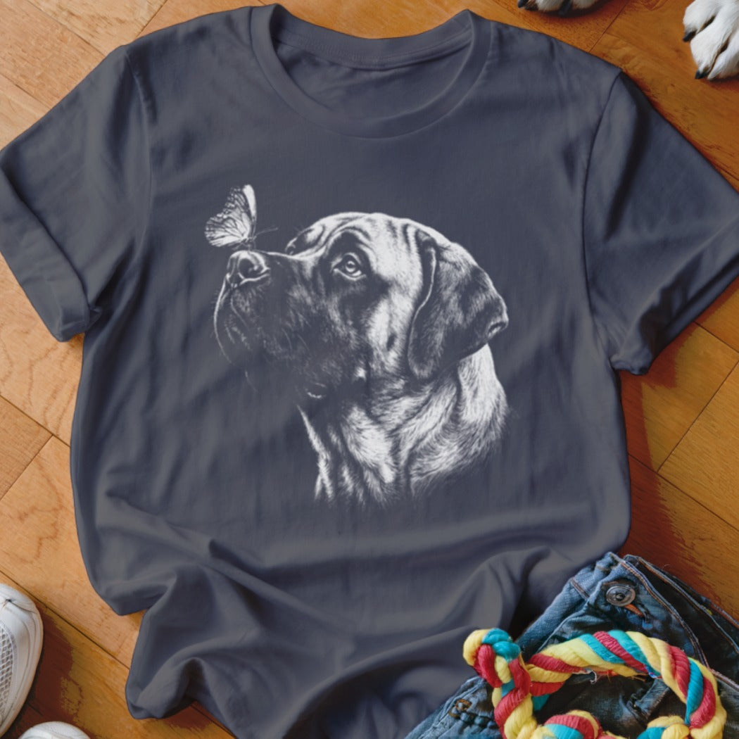 A dark gray crewneck t-shirt featuring a white sketch graphic of a dog looking at a butterfly on its nose.