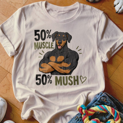 Cream t-shirt with a graphic of a muscular Doberman and text "50% MUSCLE, 50% MUSH".