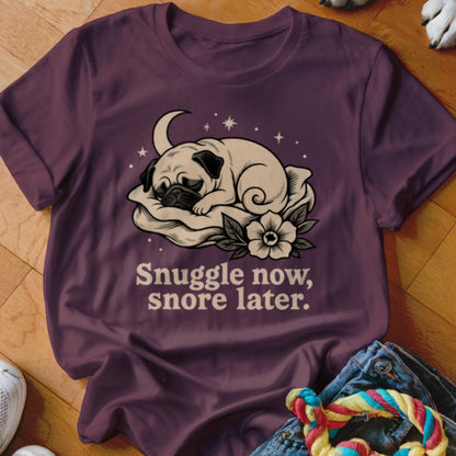 Plum t-shirt with a sleeping pug illustration and the text "Snuggle now, snore later."
