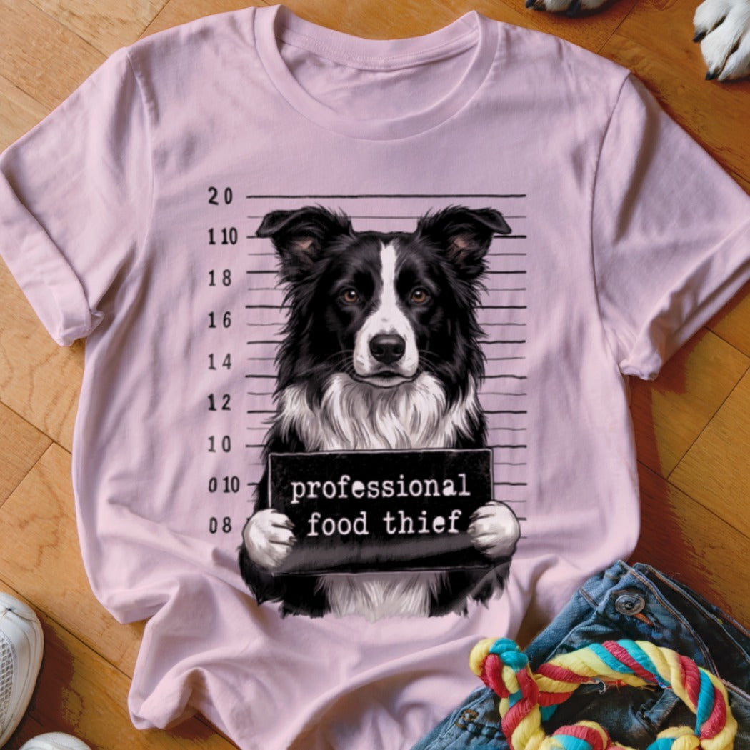 Border collie mugshot with "professional food thief" text on sign.
