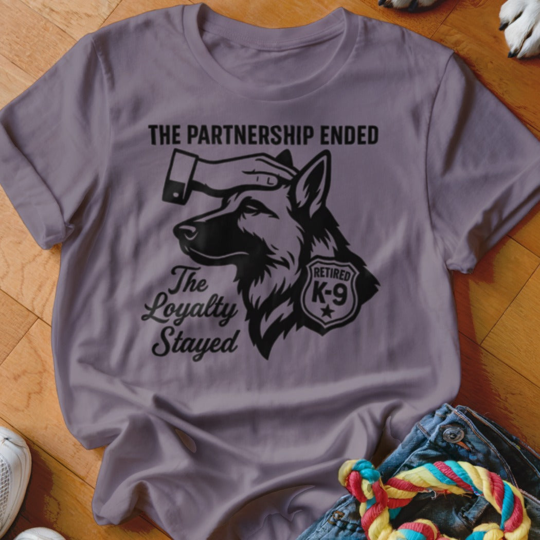 T-shirt with graphic of German Shepherd, hand petting head, "Retired K-9", and text "The Partnership Ended The Loyalty Stayed".