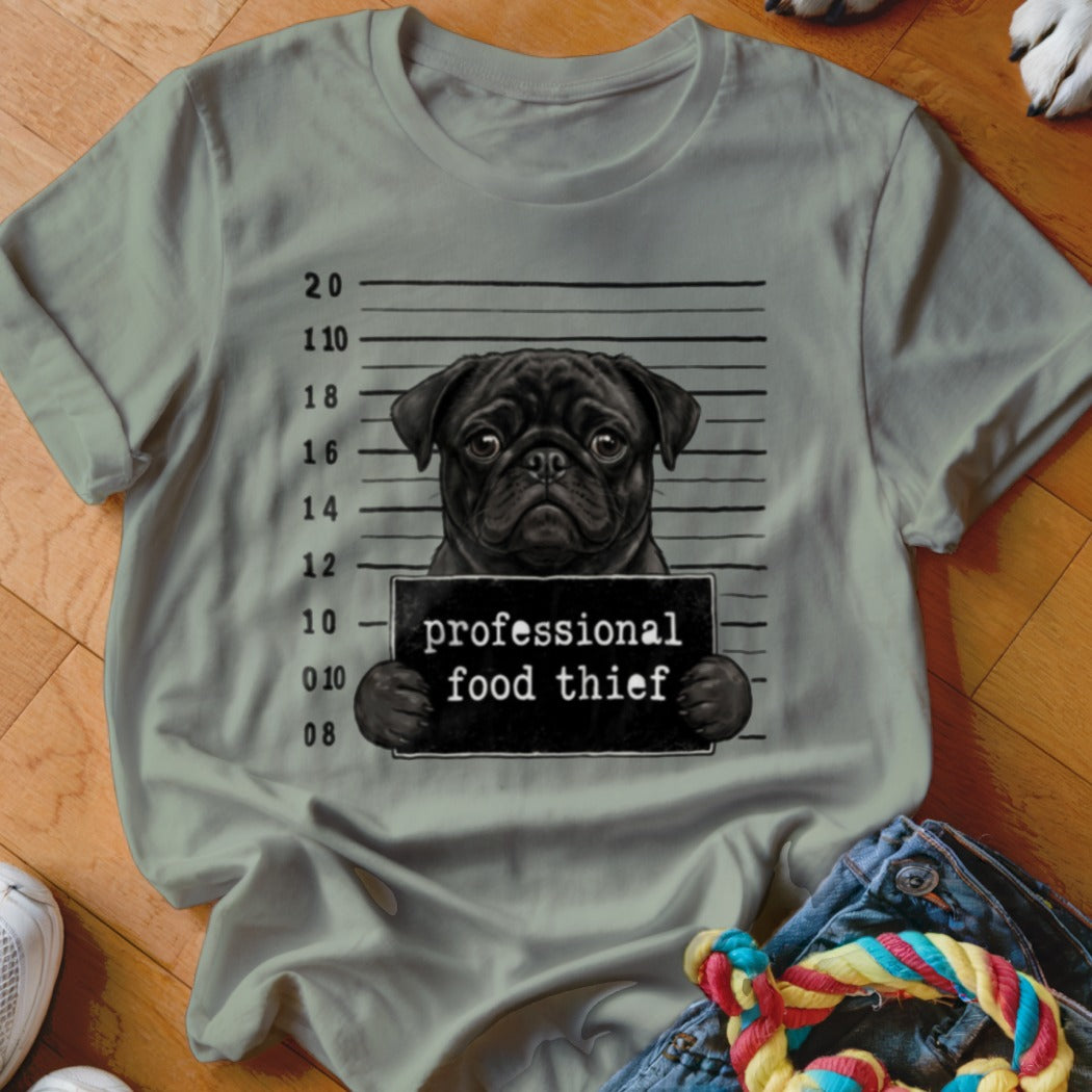 T-shirt with a black pug in a mugshot holding a "professional food thief" sign.