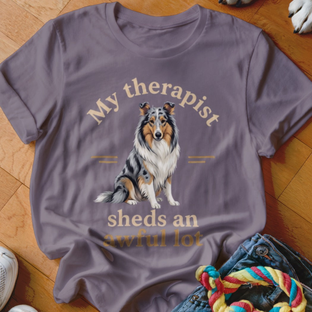 Collie dog graphic on a purple t-shirt with text "My therapist sheds an awful lot."