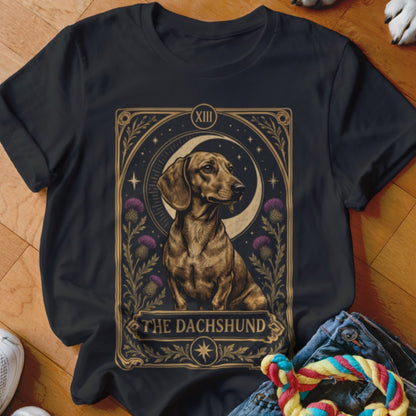 Black t-shirt featuring a tarot-style graphic of a dachshund with a crescent moon and thistles.