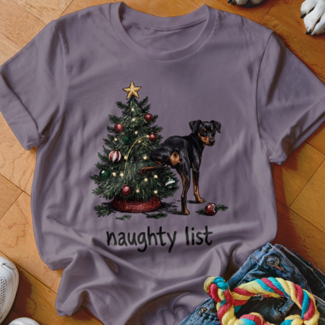 A dog lifts its leg on a Christmas tree with "naughty list" text.