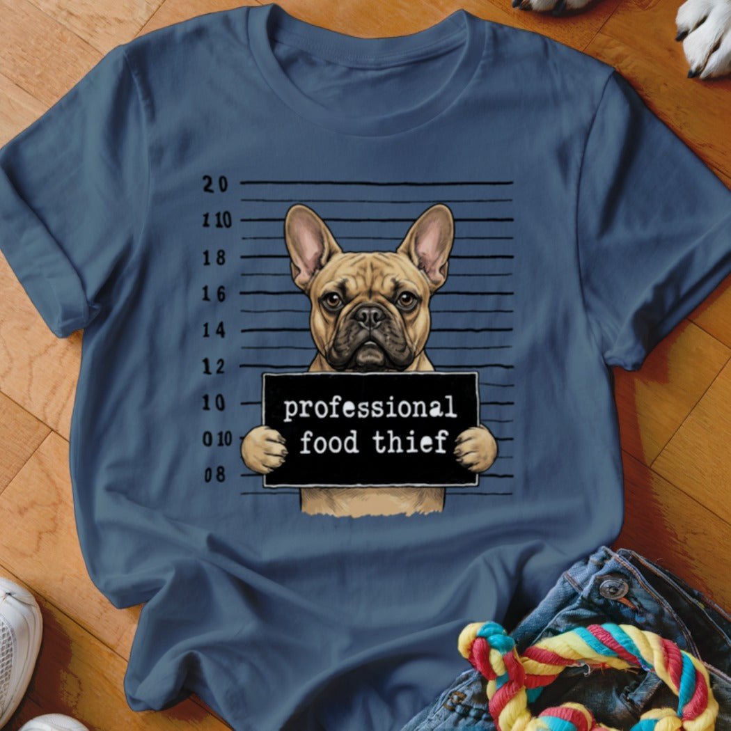 French bulldog with "professional food thief" sign against a police lineup background.