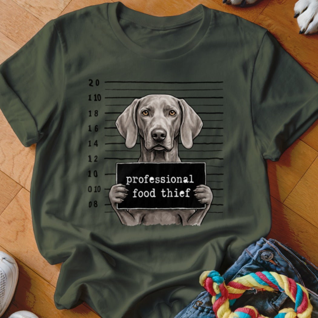 Green t-shirt with Weimaraner mugshot holding "professional food thief" sign.