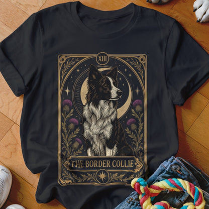 Black t-shirt featuring a tarot card style illustration of a Border Collie flanked by purple thistles.