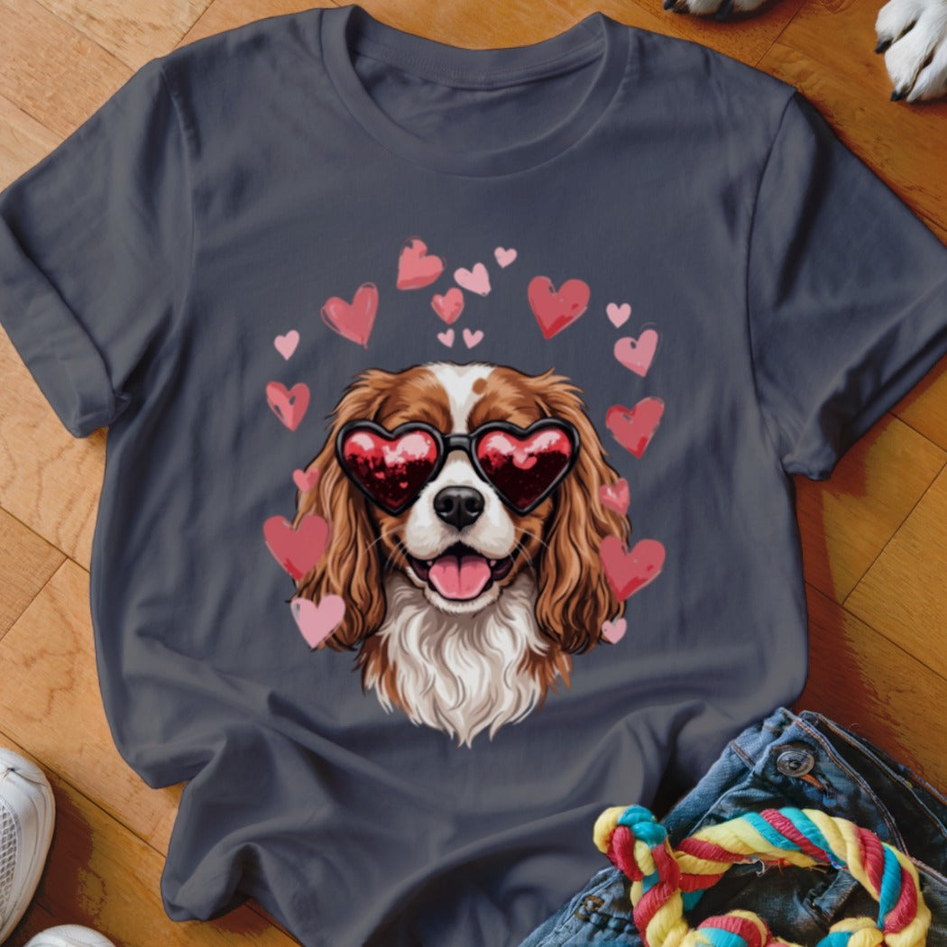 A dark gray crewneck t-shirt featuring a graphic of a brown and white dog wearing heart-shaped sunglasses, surrounded by pink hearts.