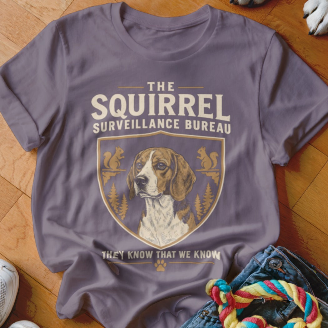 Purple t-shirt featuring a beagle graphic with text that reads The Squirrel Surveillance Bureau.