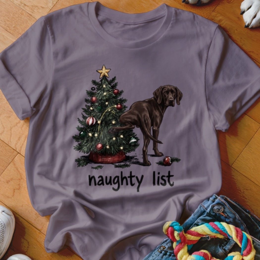 Brown dog peeing on a Christmas tree with the text "naughty list".