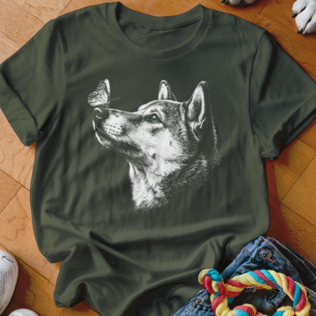 Dark green t-shirt featuring a white sketched graphic of a dog looking up at a butterfly.