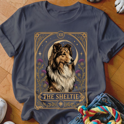 Dark gray crewneck t-shirt featuring a tarot card style illustration of a Sheltie dog.