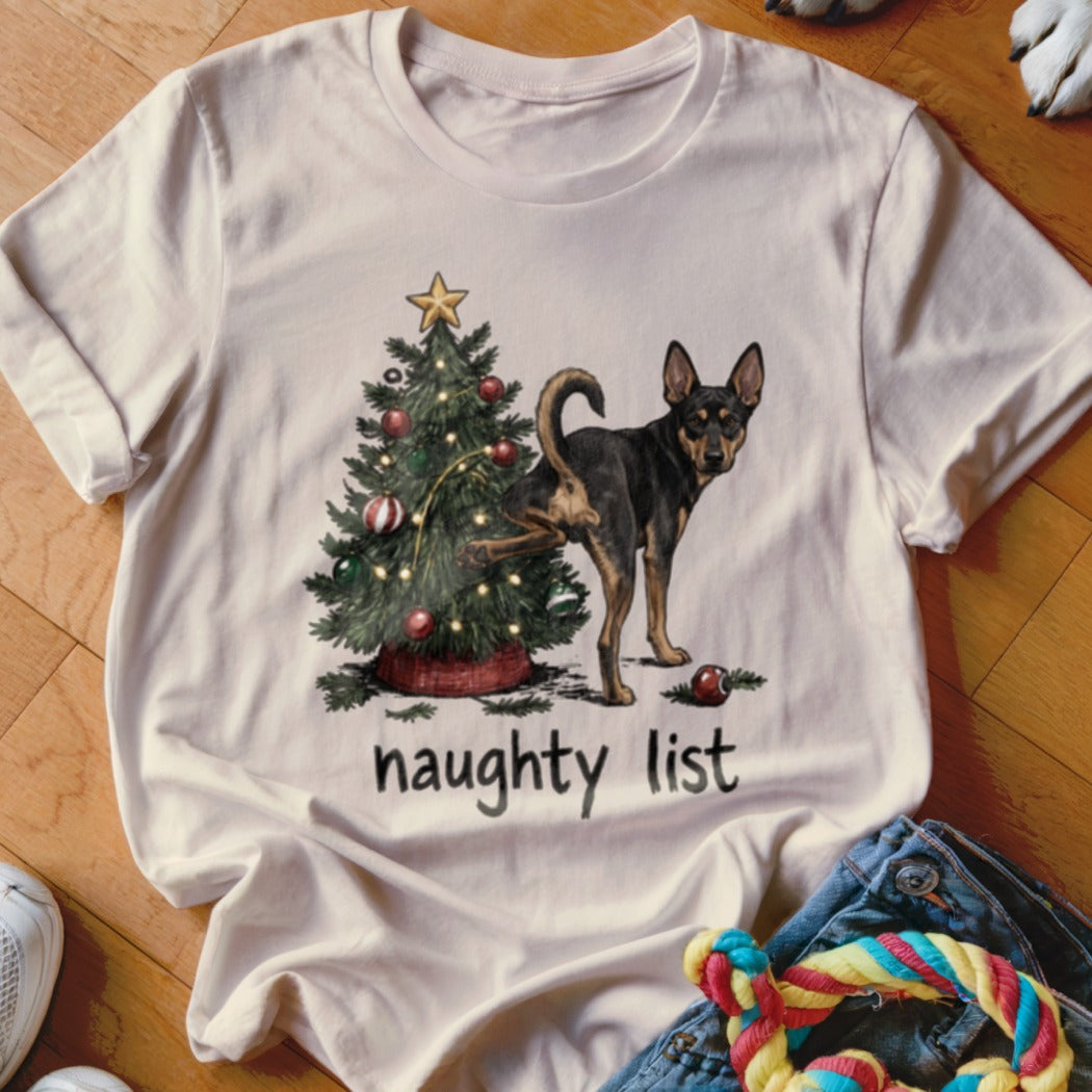 T-shirt with dog lifting leg on Christmas tree, text "naughty list".