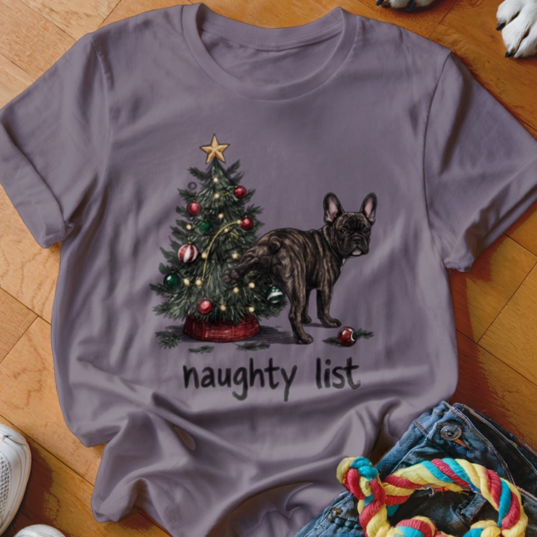 French bulldog near Christmas tree with text "naughty list".