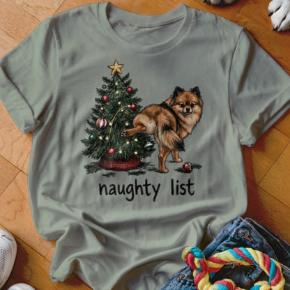 Pomeranian dog at Christmas tree with text "naughty list"