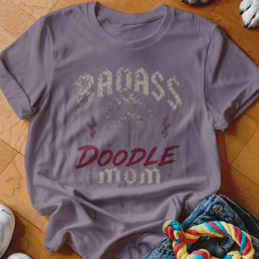 Purple t-shirt with distressed text "BADASS DOODLE MOM" and a doodle face graphic.