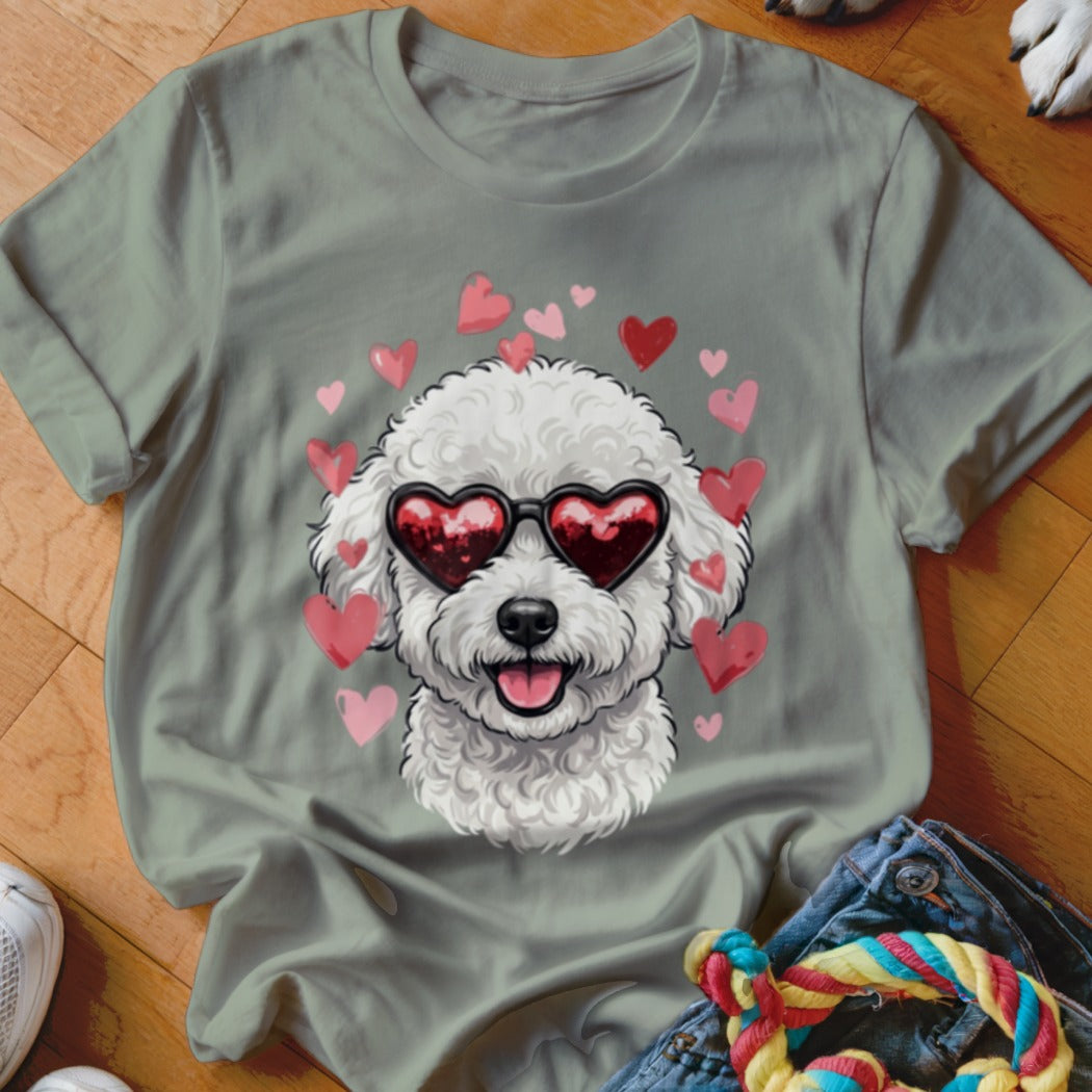 Sage green t-shirt featuring a graphic of a white poodle wearing heart-shaped sunglasses surrounded by pink hearts.