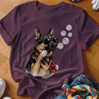 A dark purple t-shirt featuring a graphic of a German Shepherd wearing sunglasses and blowing bubbles.